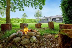 a fire pit in the middle of a yard at 30512-Odder-Hasselvaenget-9 in Odder