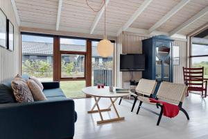 a living room with a couch and a table and chairs at 30430-Odder-Strandvaenget-15 in Odder