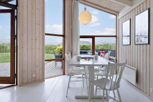 a dining room with a white table and chairs at 30430-Odder-Strandvaenget-15 in Odder +26 photos