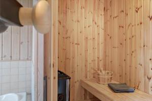 a bathroom with wooden walls and a counter with a bucket at 30430-Odder-Strandvaenget-15 in Odder