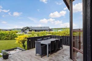 a patio with a table and chairs on a deck at 30430-Odder-Strandvaenget-15 in Odder