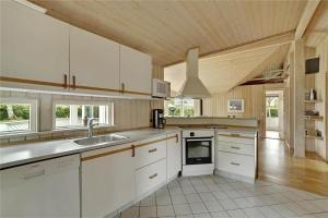 a kitchen with white cabinets and a sink at 30410-Odder-Hulager-2 in Odder +24 photos