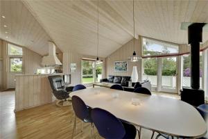 a dining room and living room with a table and chairs at 30410-Odder-Hulager-2 in Odder