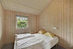 a bedroom with a bed in a room with a window at 30410-Odder-Hulager-2 in Odder