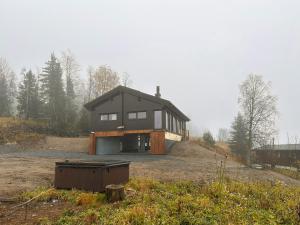 a house sitting on top of a hill at Architect-Designed Log Cabin By Myllavannet in Lunner +15 photos
