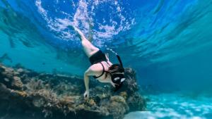 Eine Frau schwimmt im Meer in der Unterkunft Camp Laya Daracoton Island in El Nido