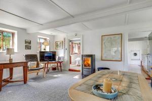 a living room with a table and a fireplace at 30580-Odder-Grindsnabevej-31 in Odder