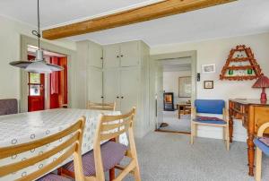 a kitchen and dining room with a table and chairs at 30580-Odder-Grindsnabevej-31 in Odder +20 photos