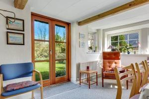 a living room with a chair and a table at 30580-Odder-Grindsnabevej-31 in Odder