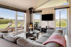 a living room with a large couch and a television at 30451-Odder-Strandvaenget-7 in Odder