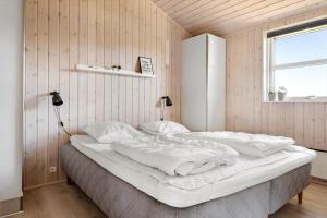 a bedroom with a large white bed with a window at 30451-Odder-Strandvaenget-7 in Odder