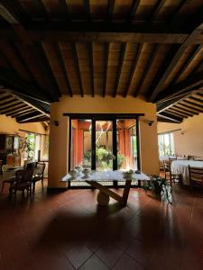 a dining room with a table in the center of a house at Mountain Farmhouse Between Parma And Cinque Terre in Solignano