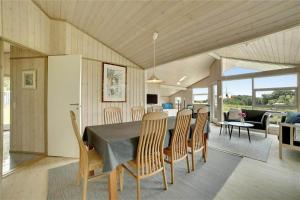 a kitchen and dining room with a table and chairs at 30727-Odder-Alrovej-203-A in Odder