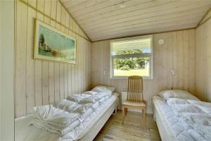 a room with two beds and a chair in it at 30727-Odder-Alrovej-203-A in Odder