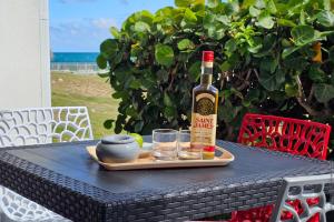 a bottle of wine and two glasses on a table at Lounge modern chill studio Orient Bay in Orient Bay