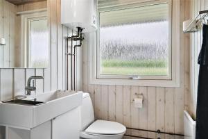 a bathroom with a sink and a toilet and a window at 30457-Odder-Snekkeager-20 in Odder