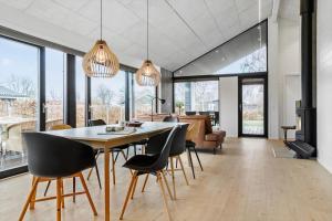 a dining room with a table and chairs at 40149-Juelsminde-Gl-Dykjaer-14 in Juelsminde