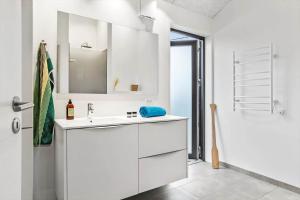 a white bathroom with a sink and a shower at 40149-Juelsminde-Gl-Dykjaer-14 in Juelsminde +29 photos