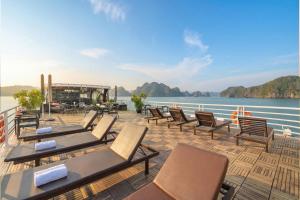 a deck with chairs and tables on a cruise ship at Beka Travel Cruise in Cat Ba