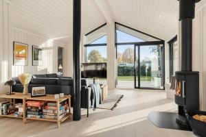 a living room with a couch and a fireplace at 30319-Odder-Grindevej-19 in Odder