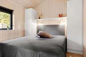 a bedroom with a bed with a pillow on it at 30319-Odder-Grindevej-19 in Odder