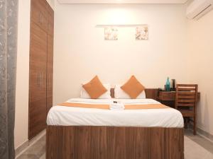 a bedroom with a large bed with a wooden headboard at Life Tree Hotel and Banquet Hall, Sector 63A in Noida