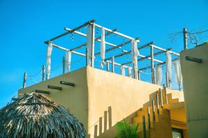 a building with a straw umbrella on top of it at Campo De Sole Villa Hoa Binh in Hòa Bình