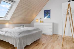 a bedroom with a bed and a large window at 40168-Juelsminde-Strandengen-52 in Juelsminde