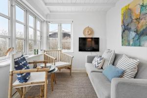 a living room with a couch and a tv at 40155-Juelsminde-Bugten-31 in Juelsminde