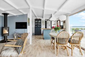 a living room with a table and chairs and a fireplace at 30725-Odder-Skovgardsparken-87 in Odder