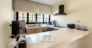 a kitchen with a counter top with a sink and a counter top at Casa Venado in Caucel