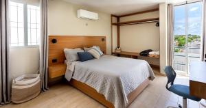 a bedroom with a bed and a large window at Casa Venado in Caucel +60 photos