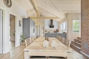 a dining room with a table and a kitchen at 30465-Odder-Stakket-Torn-9 in Odder