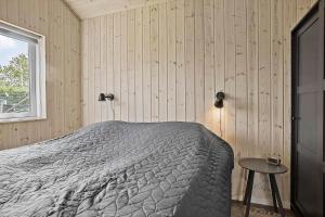 a bedroom with a bed and a window at 30465-Odder-Stakket-Torn-9 in Odder