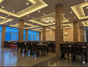 a dining room with tables and chairs and a clock on the ceiling at Silver oak Hotel and Restaurant in Pāndoh