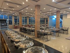 a row of dishes on a buffet in a restaurant at Silver oak Hotel and Restaurant in Pāndoh