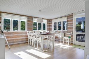 a dining room with a table and chairs and windows at 30355-Odder-Granvej-14 in Odder +21 photos