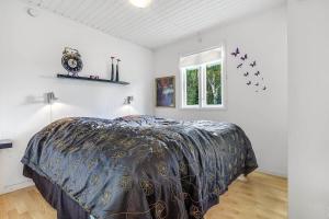 a bedroom with a bed in a room with a window at 30355-Odder-Granvej-14 in Odder
