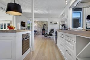 a kitchen with white cabinets and a counter top at 30355-Odder-Granvej-14 in Odder