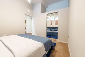 a white bedroom with a bed and a mirror at 2 BHK Unit In Core Downtown Cincy in Cincinnati +50 photos