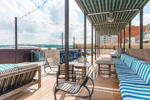 a patio with benches and tables on a roof at 2 BHK Unit In Core Downtown Cincy in Cincinnati