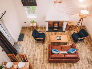 an overhead view of a living room with a couch and chairs at An Dobhran - Ukc5752 in Dornie