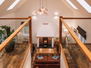 a living room with a staircase with a fireplace at An Dobhran - Ukc5752 in Dornie