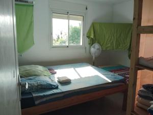 a bed in a room with a window at La chambre Ganesh in Saint-André