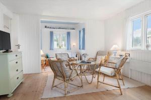 a living room with a table and chairs at 40161-Juelsminde-Bugten-30 in Juelsminde
