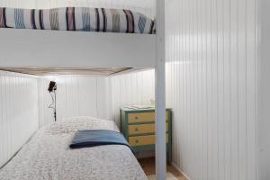 a bedroom with a bunk bed and a night stand at 40161-Juelsminde-Bugten-30 in Juelsminde +26 photos
