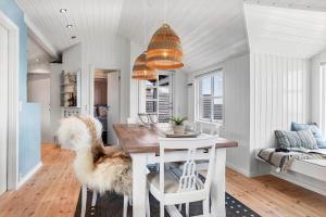 a kitchen and dining room with a table and a couch at 30594-Odder-Toldvejen-45-H in Odder