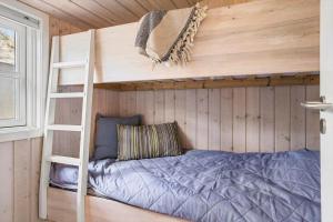 a bunk bed in a tiny house with a ladder at 30594-Odder-Toldvejen-45-H in Odder