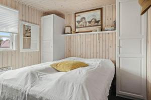 a bedroom with a bed with a yellow pillow on it at 40159-Juelsminde-Mirabellevej-1 in Juelsminde +24 photos