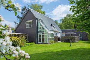 a house with a gray roof and a yard at 40117-juelsminde-Gludvej-7 in Juelsminde